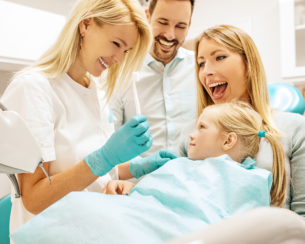 A family is getting their teeth checked using dental services.