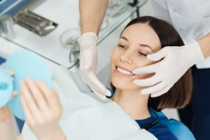 a woman is thrilled with the results of her cosmetic dental bonding procedure